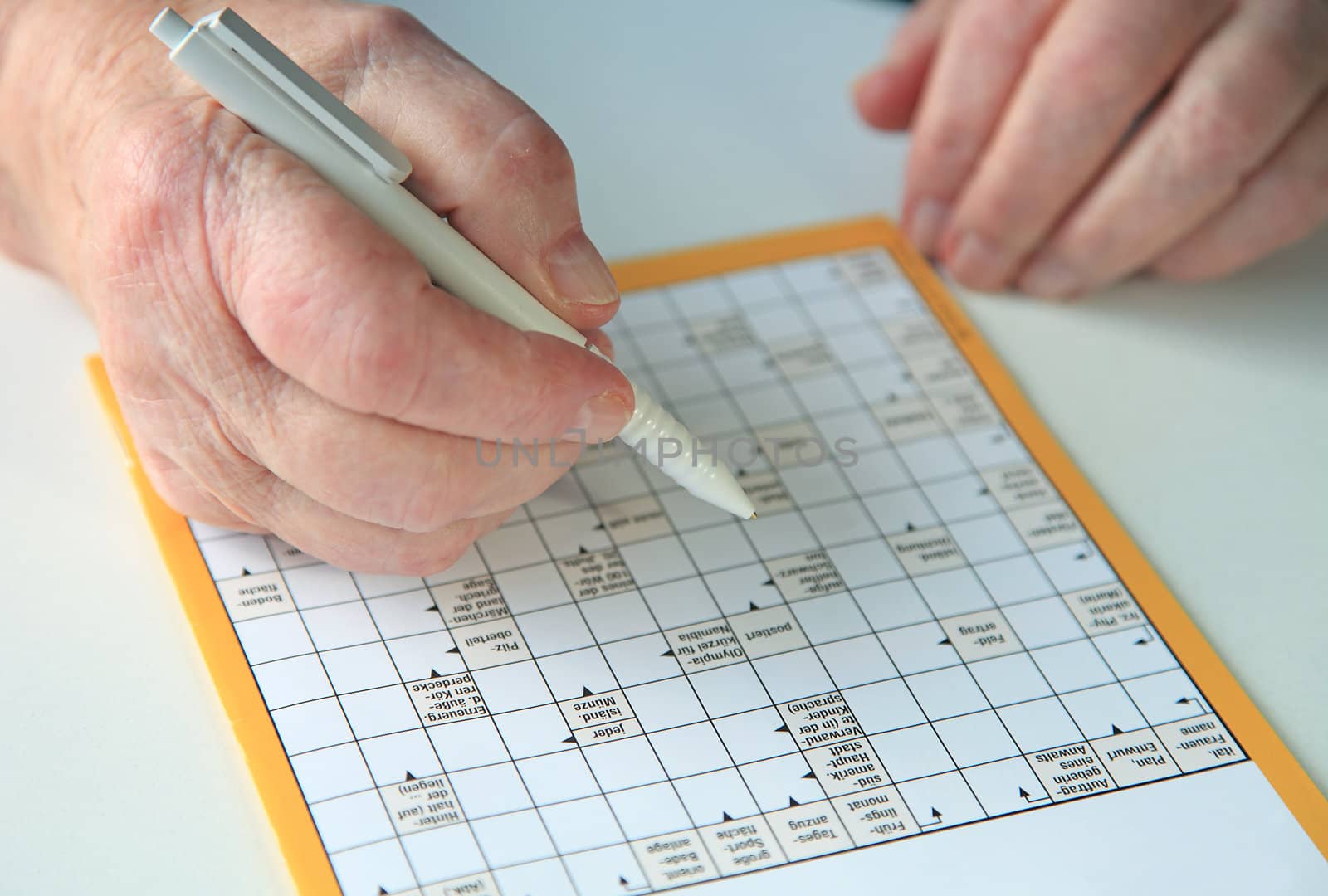 Senior doing crossword puzzle.