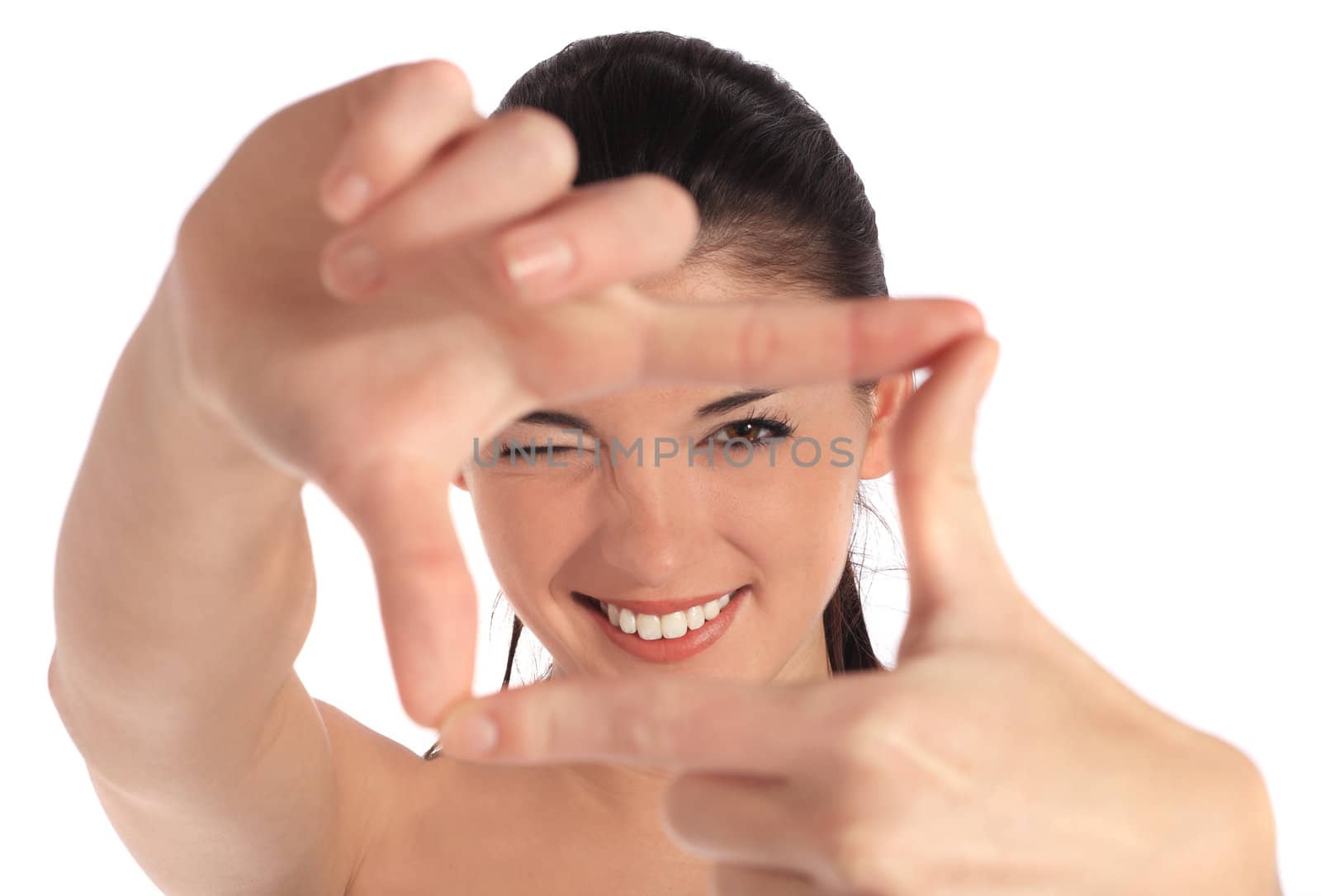 Attractive young woman building a frame out of her hands. All on white background.