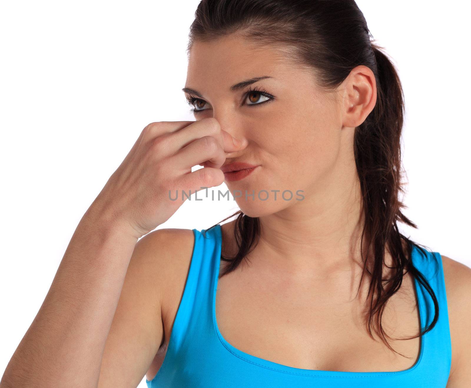 Attractive young woman smells something ugly. All on white background.