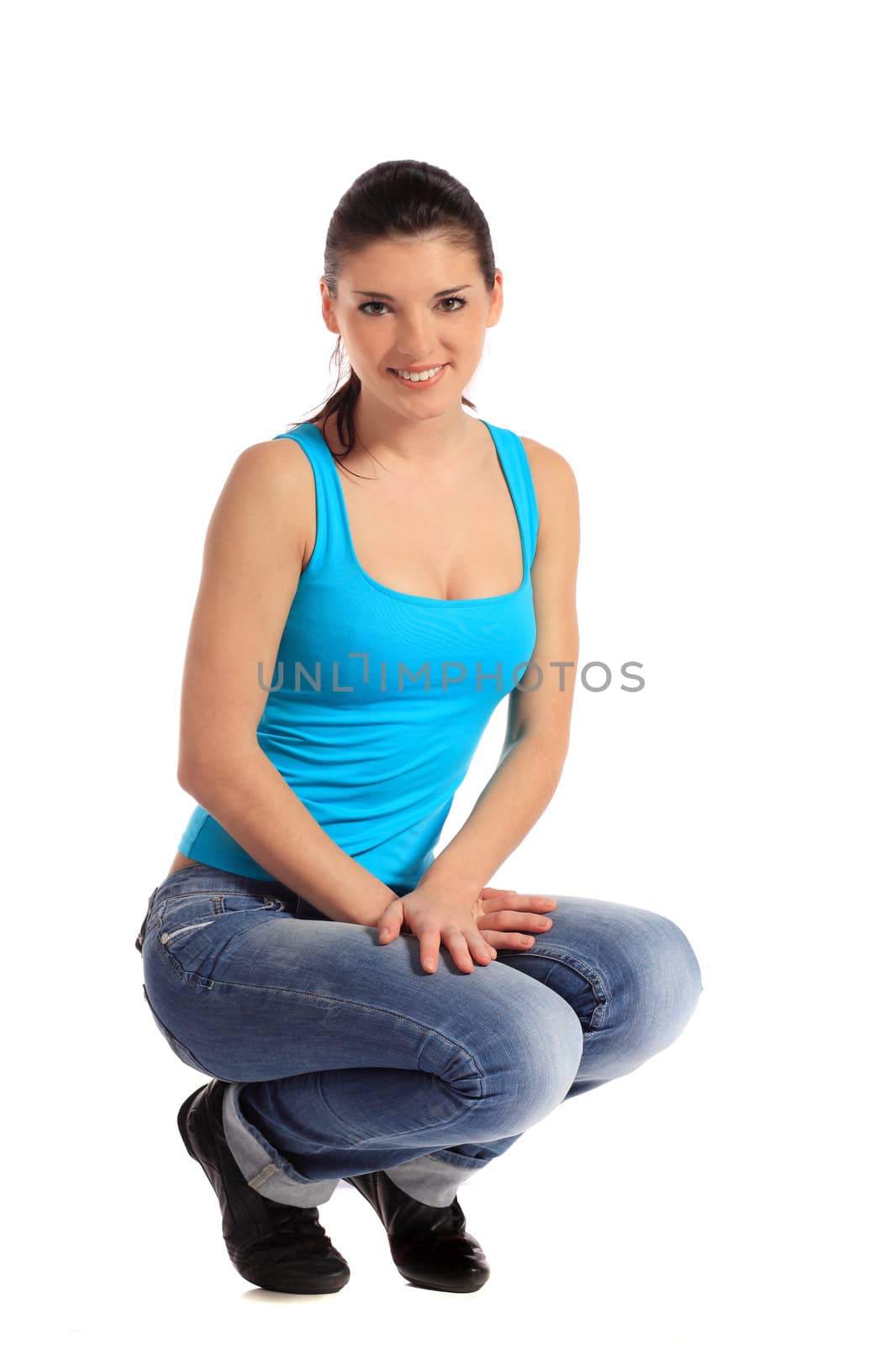 Attractive young woman in squatting position. All on white background.
