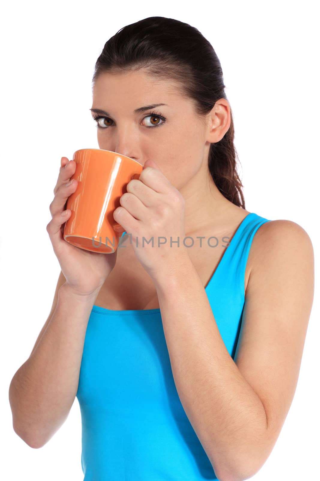 Attractive young woman drinking out of a mug. All on white background.