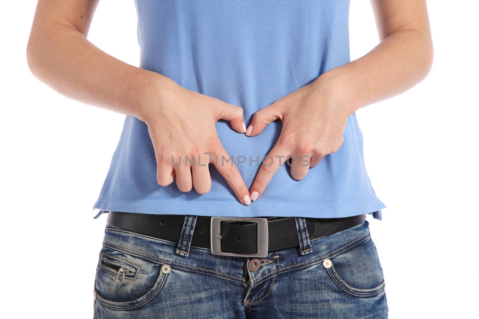 Torso of a female person building a heart out of her hands on her belly. All on white background.