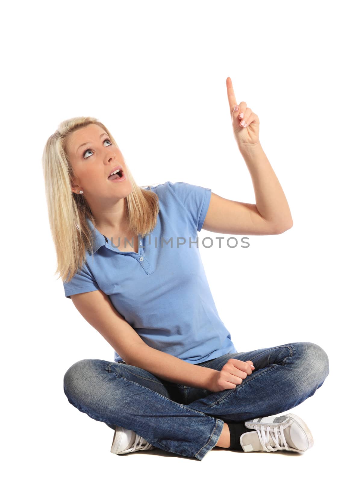 Attractive young woman pointing with finger. All on white background.