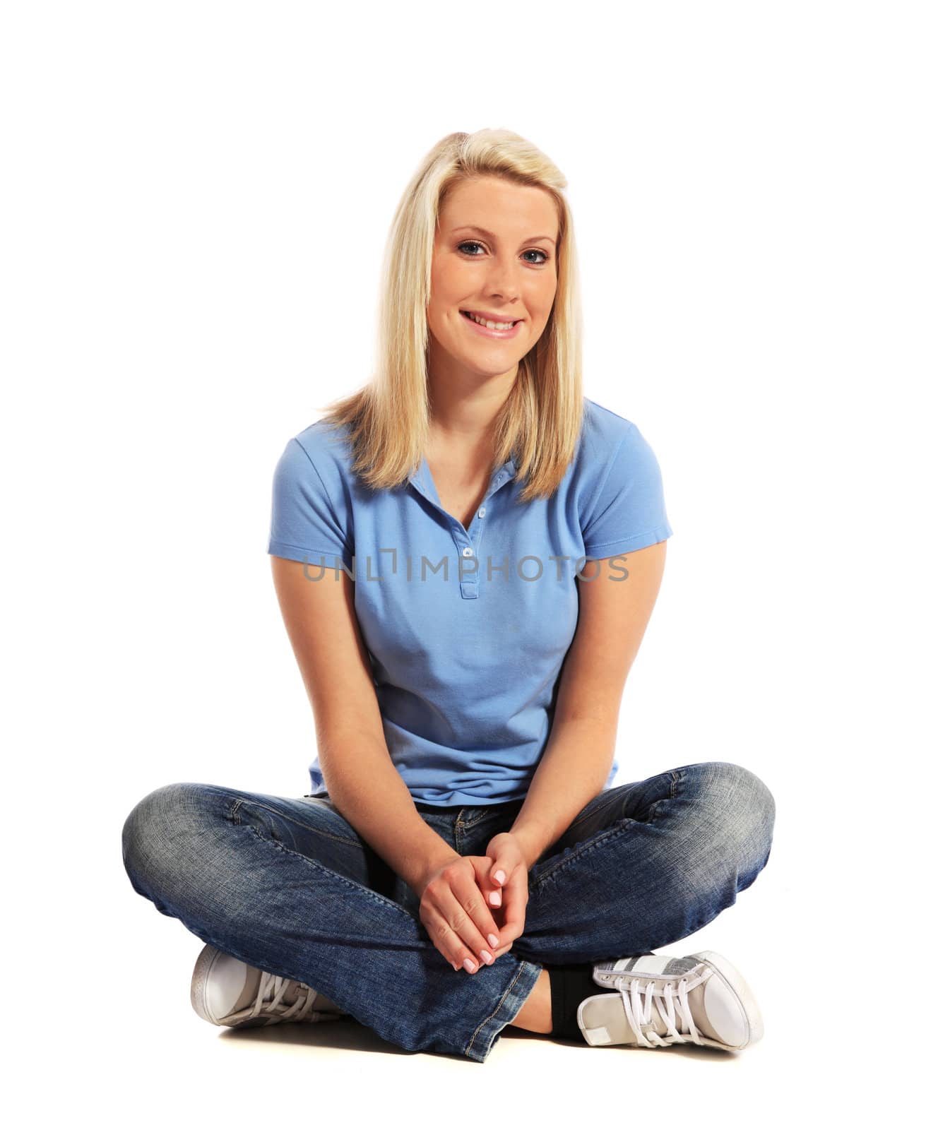 Attractive young woman sitting. All on white background.