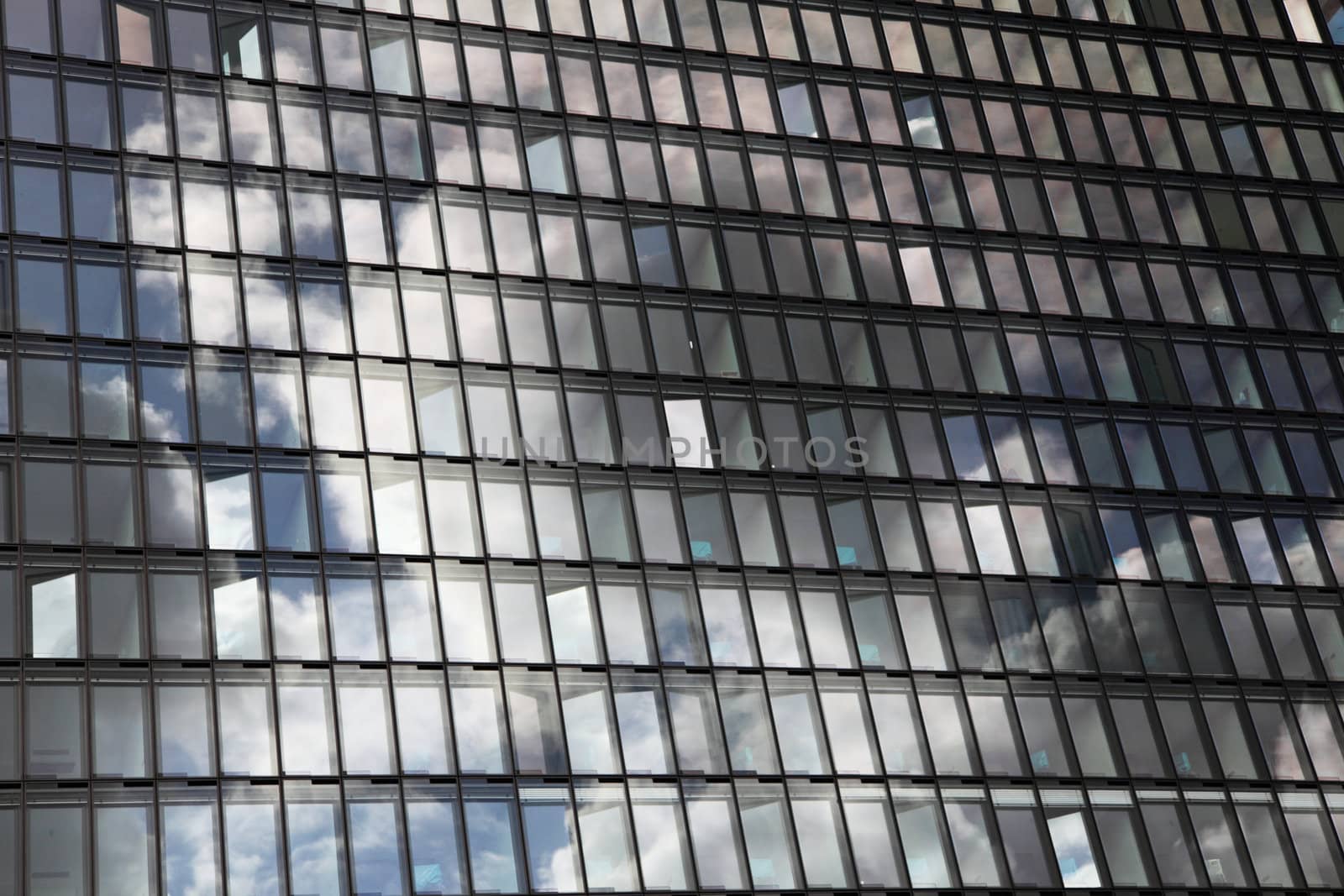 Cloudy sky reflects in a glassy house front