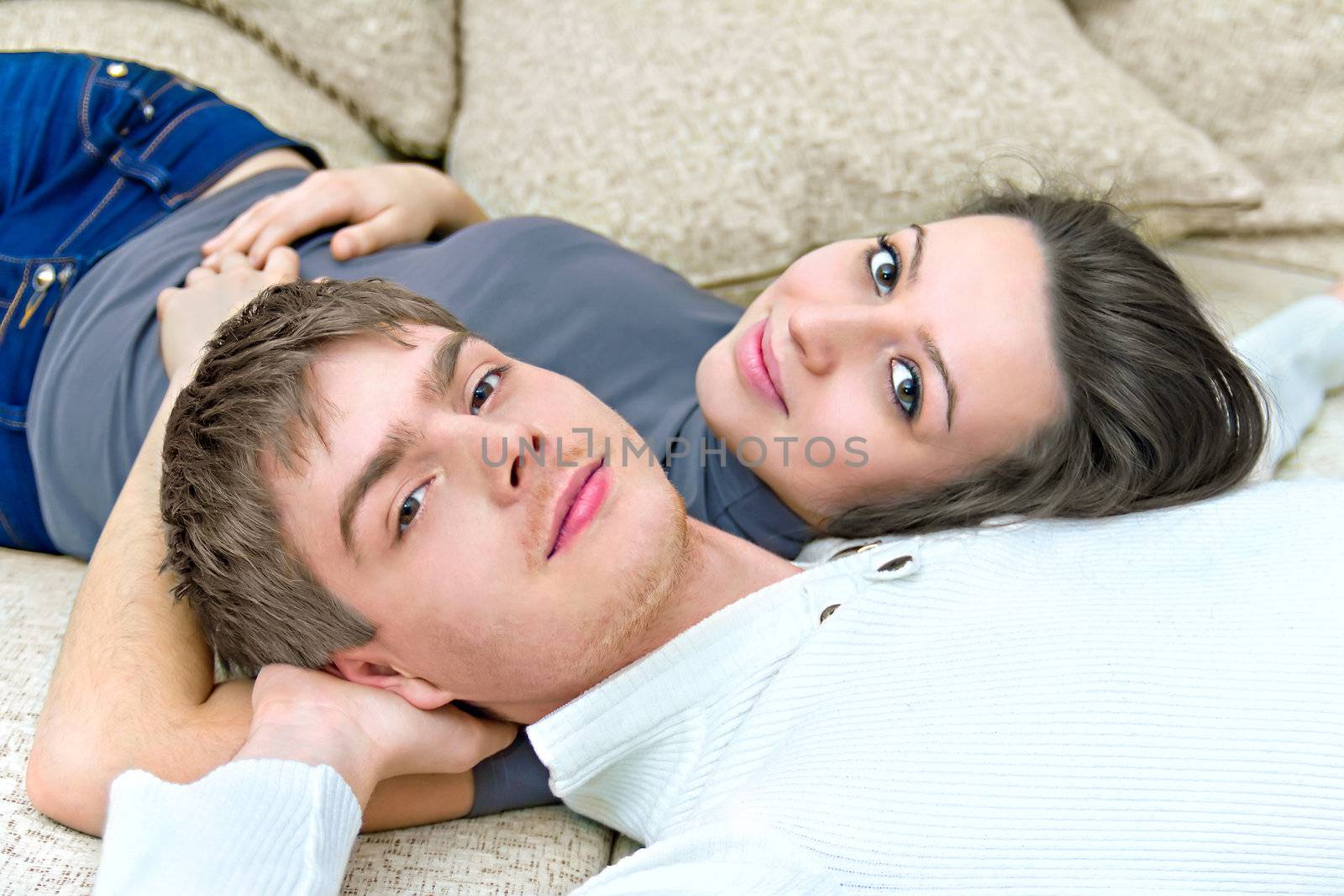 young guy and a girl lying on the couch by Plus69