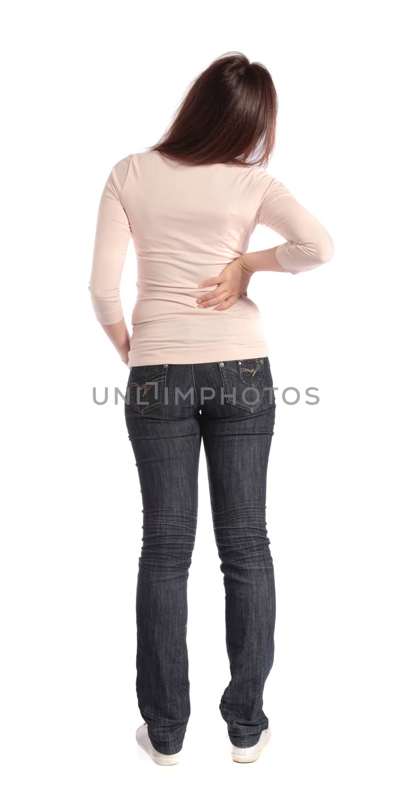 Full length shot of an attractive young woman suffering from backache. All on white background.