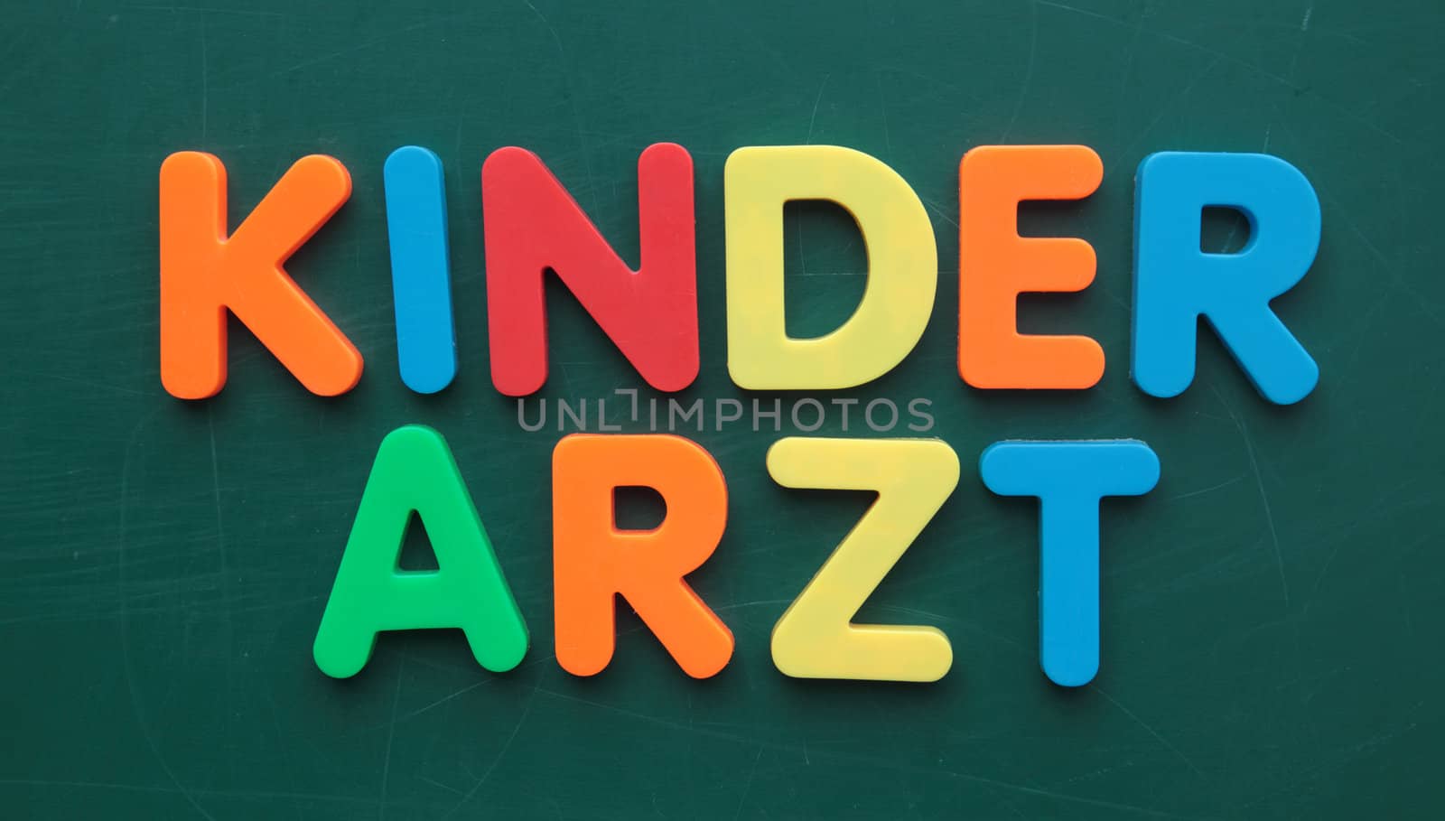 German term for pediatrician in colorful letters on a blackboard.