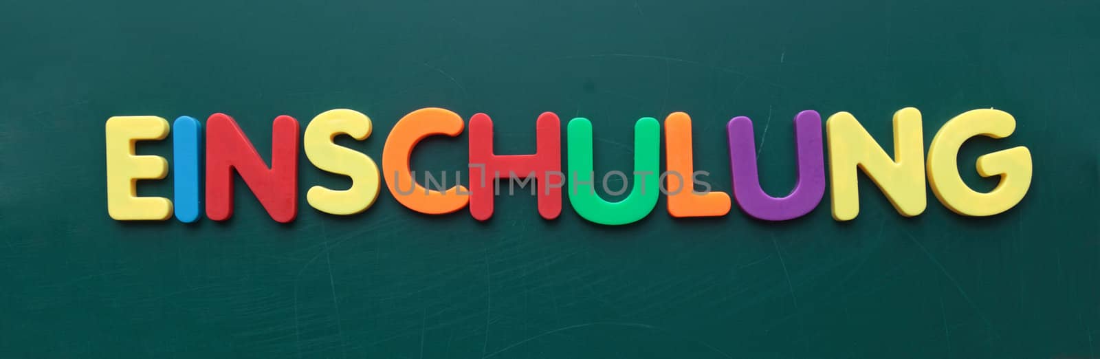 The german term for enrollment in colorful letters on a blackboard.