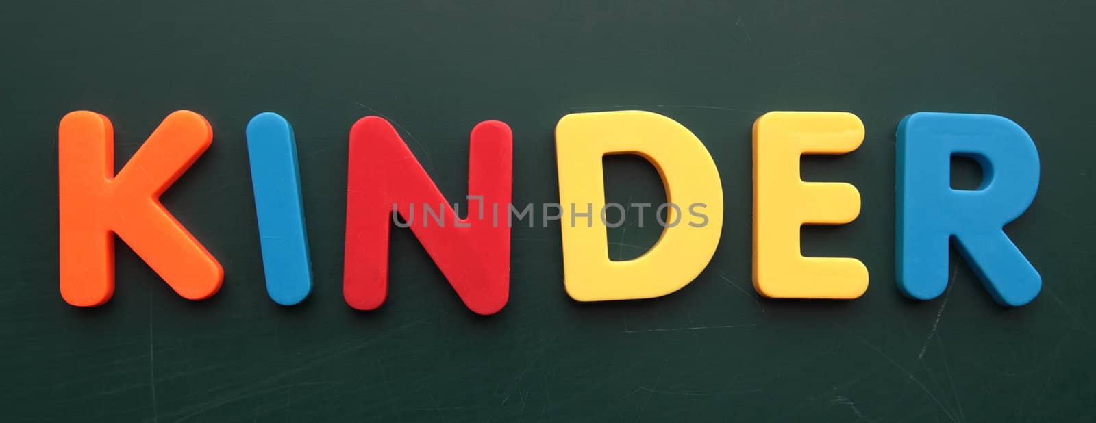 German term for children in colorful letters on a blackboard.