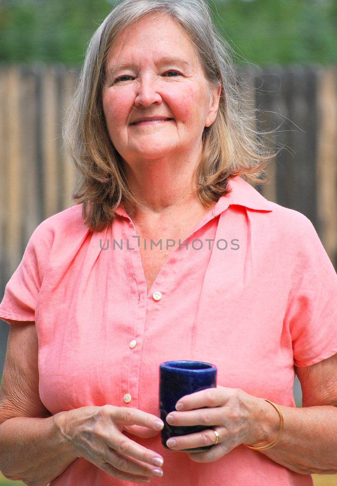 Mature female beauty posing outside.