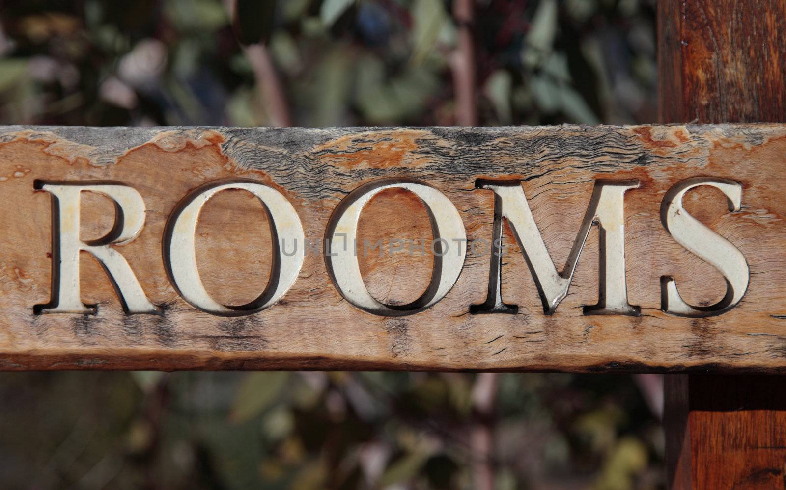 The term rooms on rustic wooden sign.