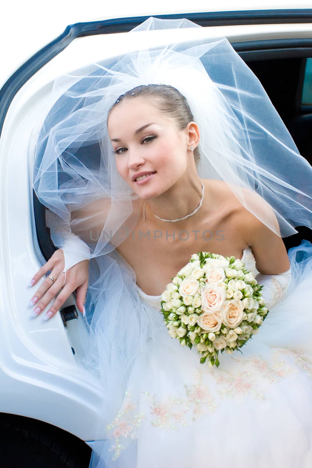 bride in the car with flowers by vsurkov