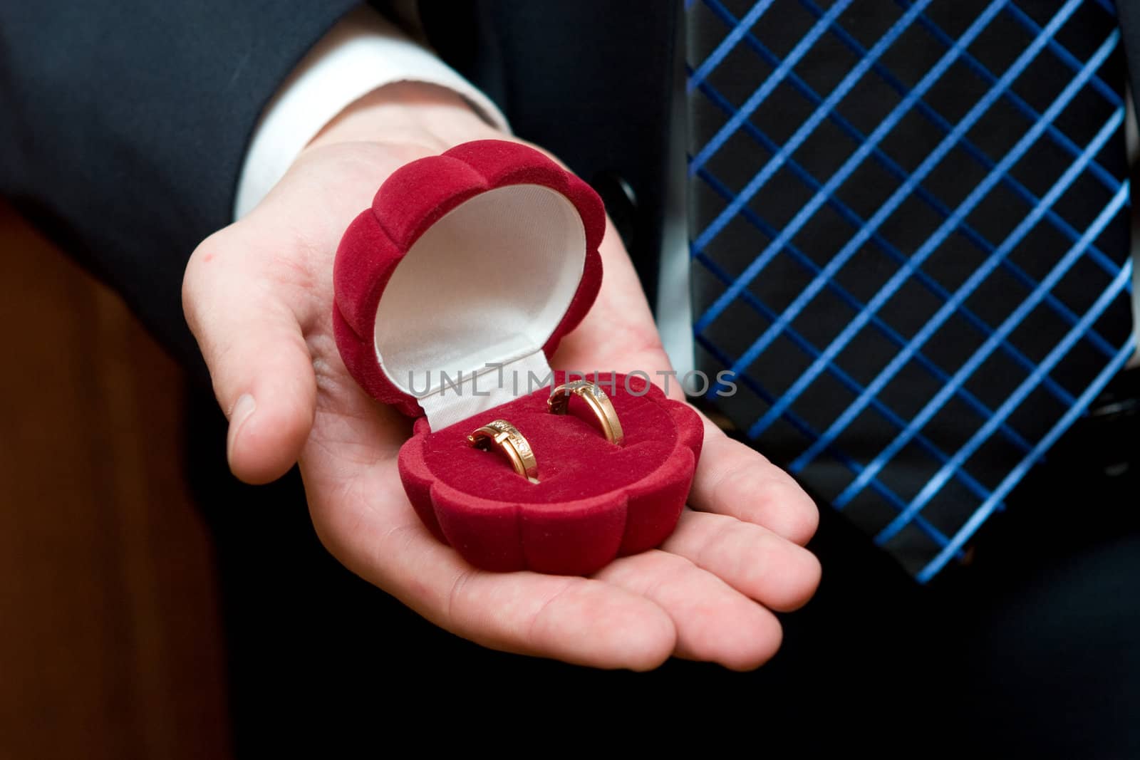 two wedding rings in the box which holds a man