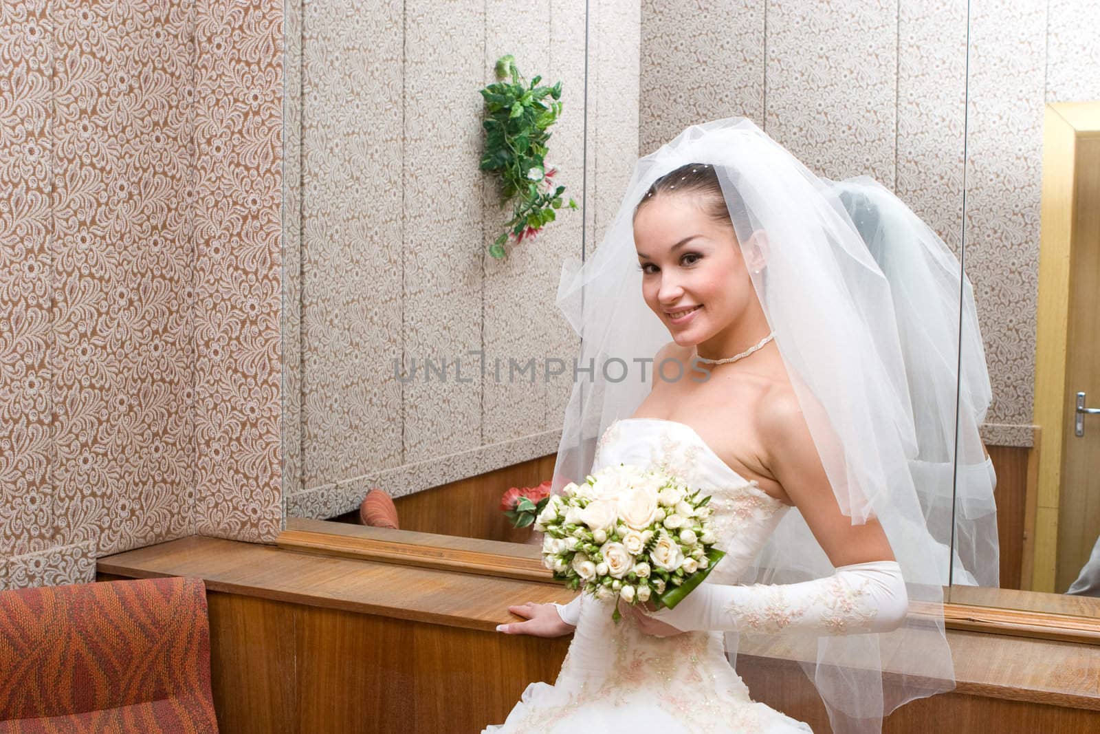 beautiful bride by a big mirror