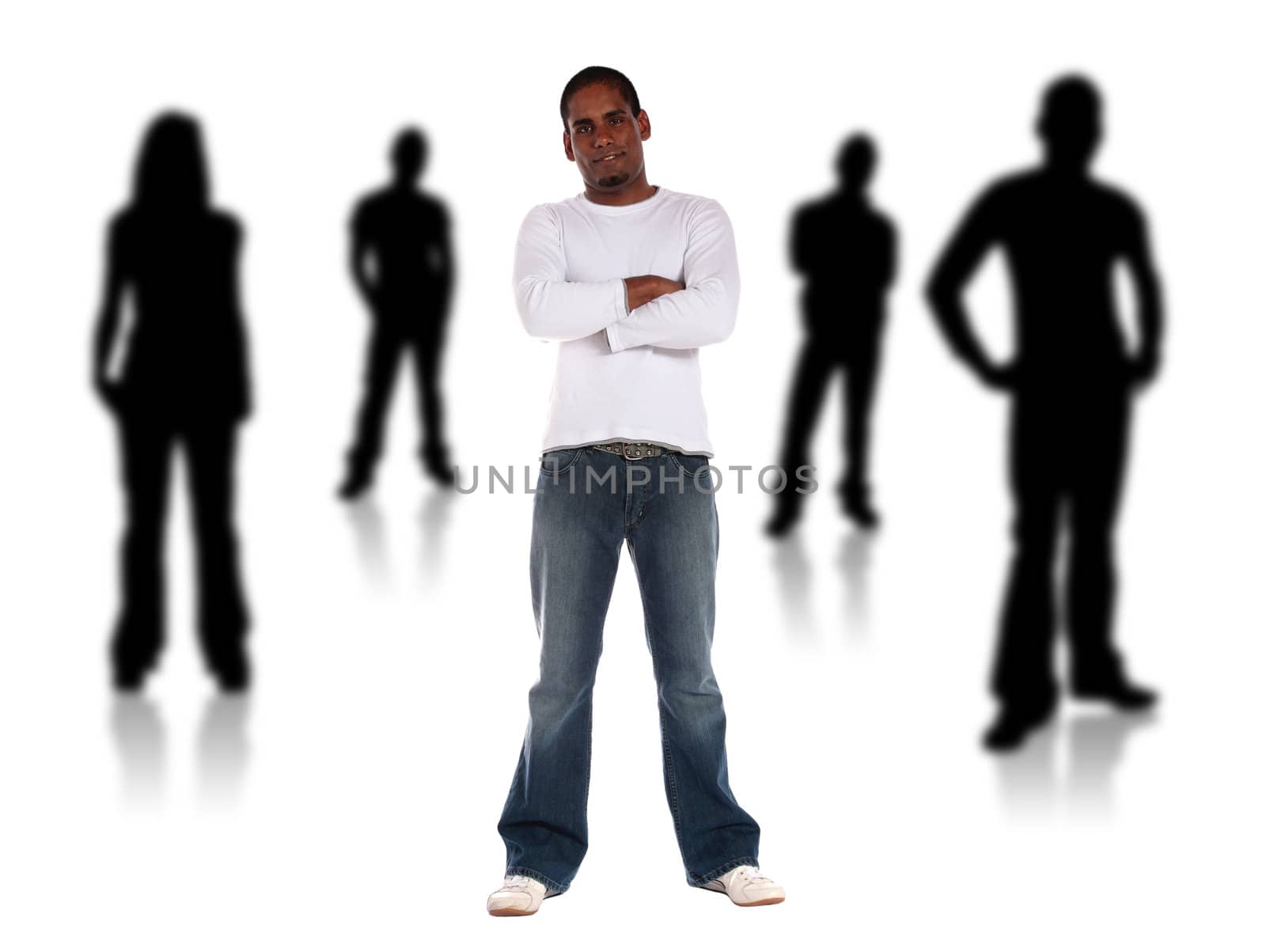 An attractive young man standing among several black silhouettes. All isolated on white background.