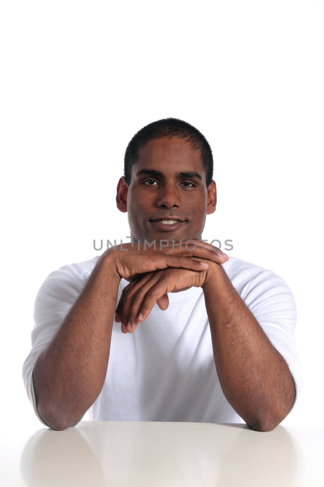 An attractive dark-skinned sitting at a table. All on white background.