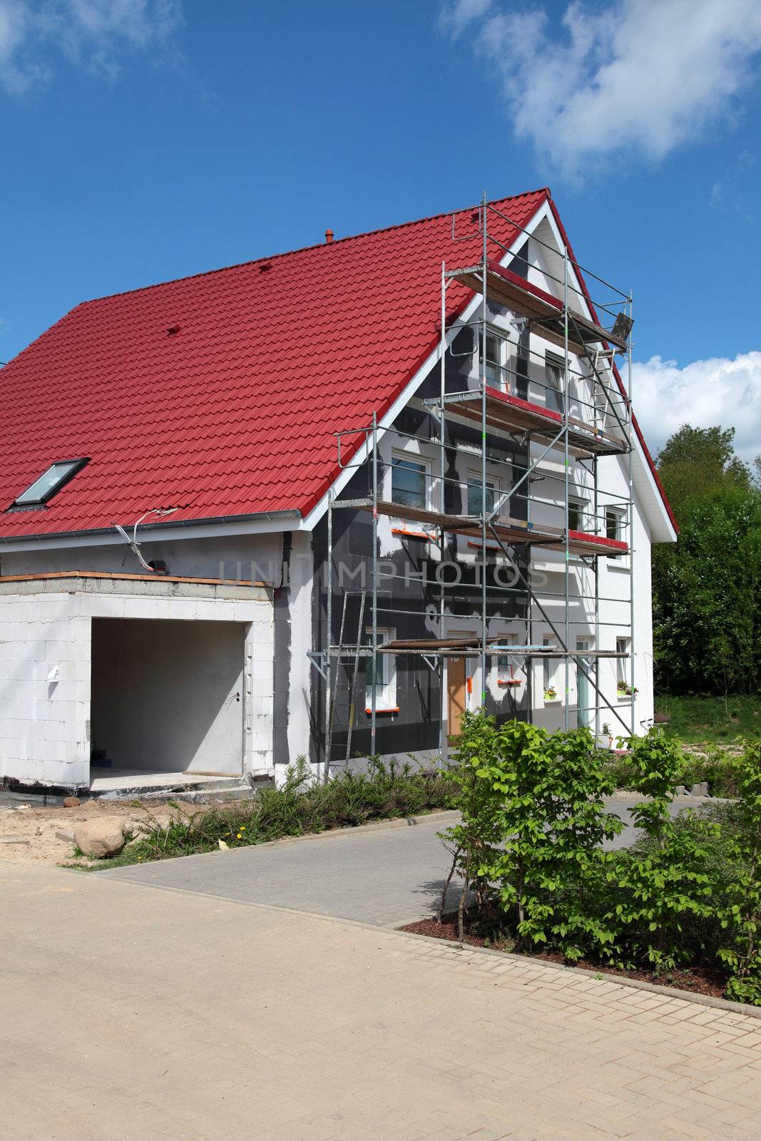 Shell construction of a typical new residential building with scaffolding.