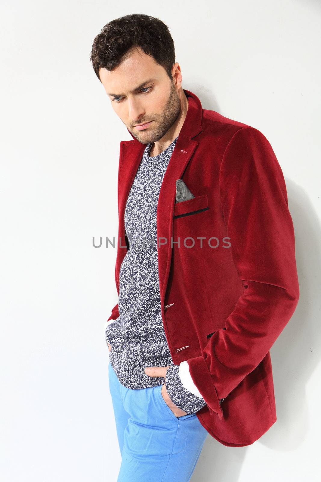 Handsome man posing in a red jacket by robert_przybysz