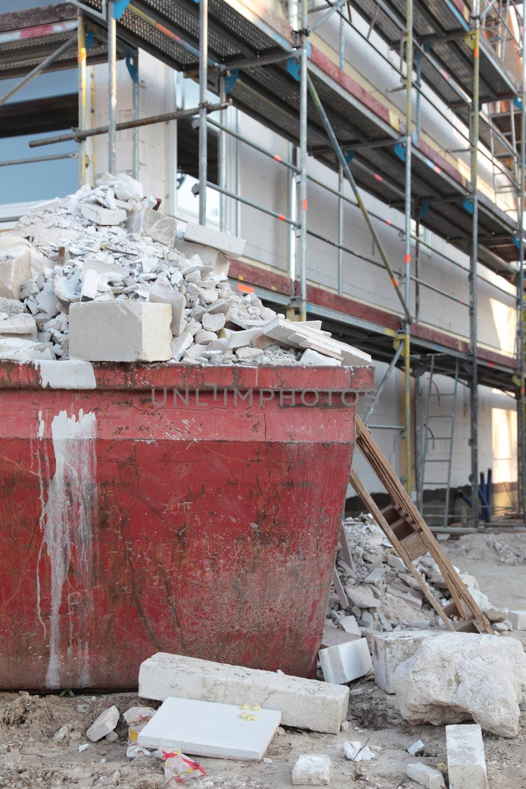 Construction rubble in front of a new residential building beeing build.