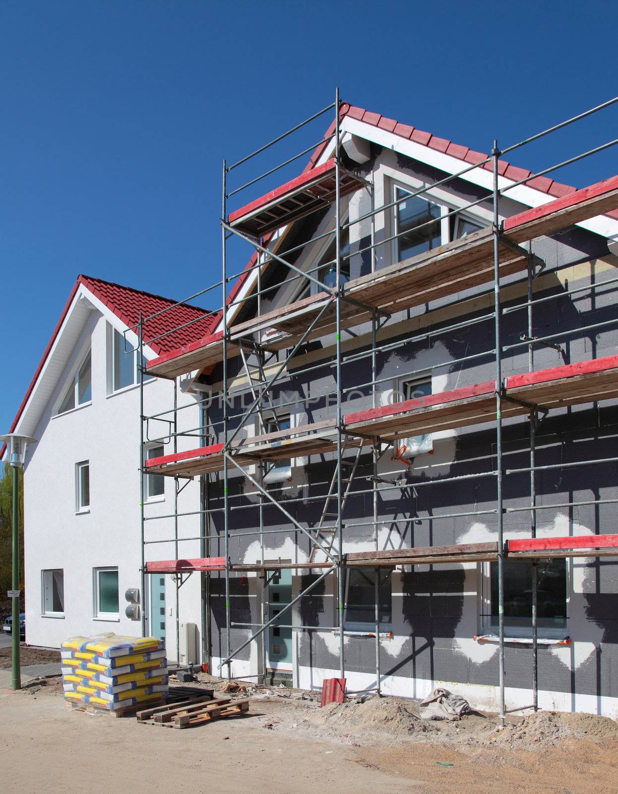 Shell construction of a typical new residential building with scaffolding.