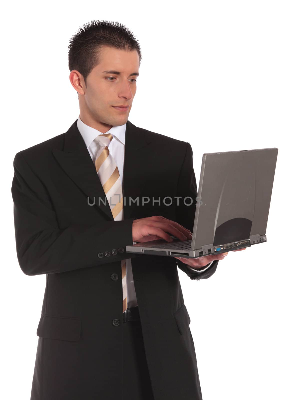 A handsome businessman holding a notebook computer. All on white background.