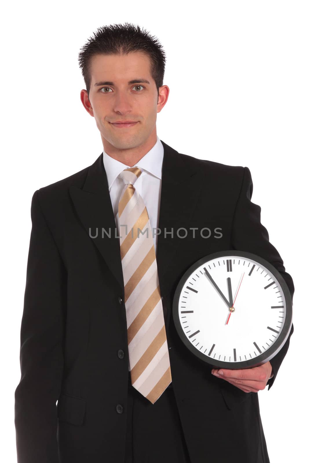 A handsome businessman holding a clock that shows the eleventh hour. All on white background.