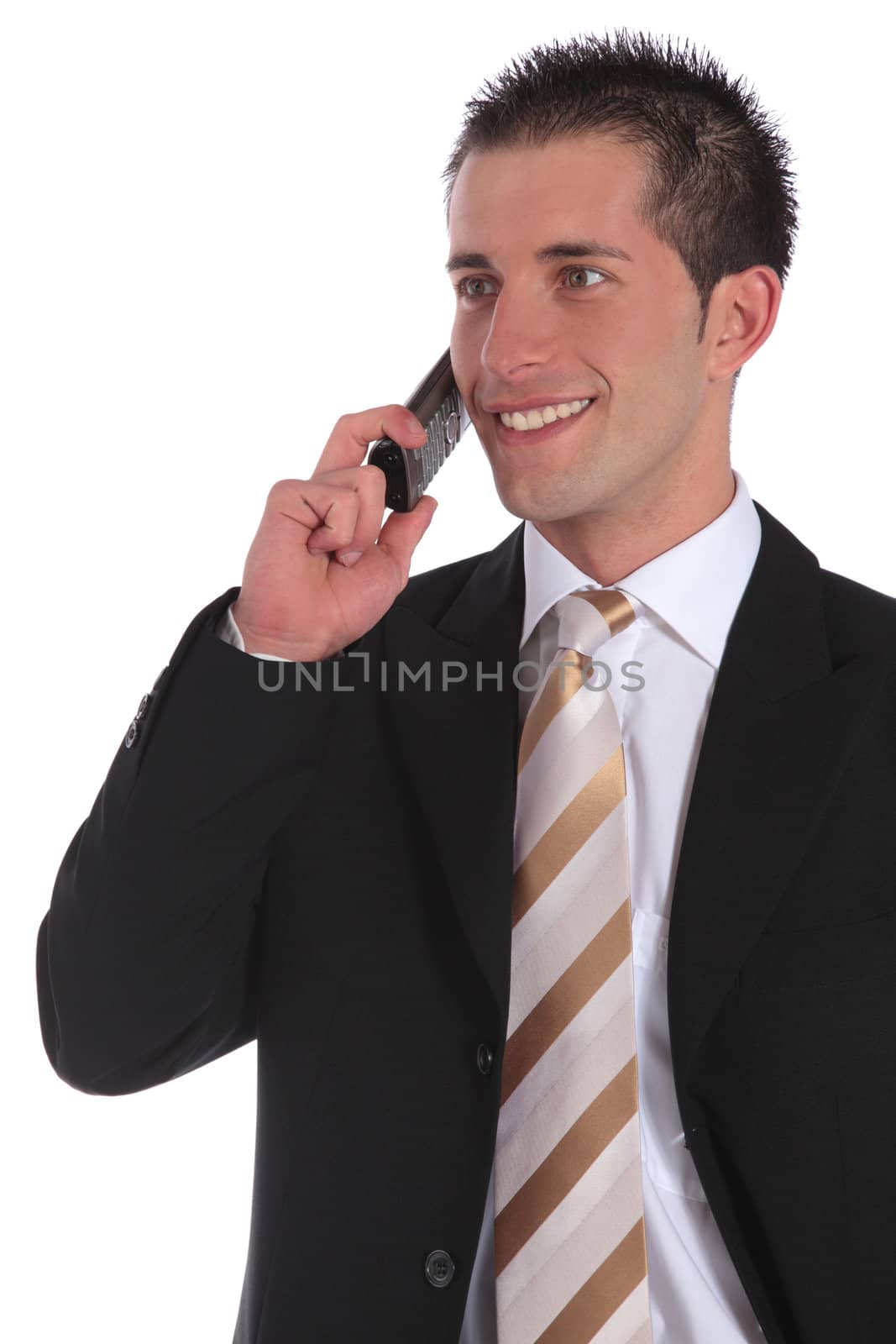 A handsome businessman gets a pleasant call. All on white background.