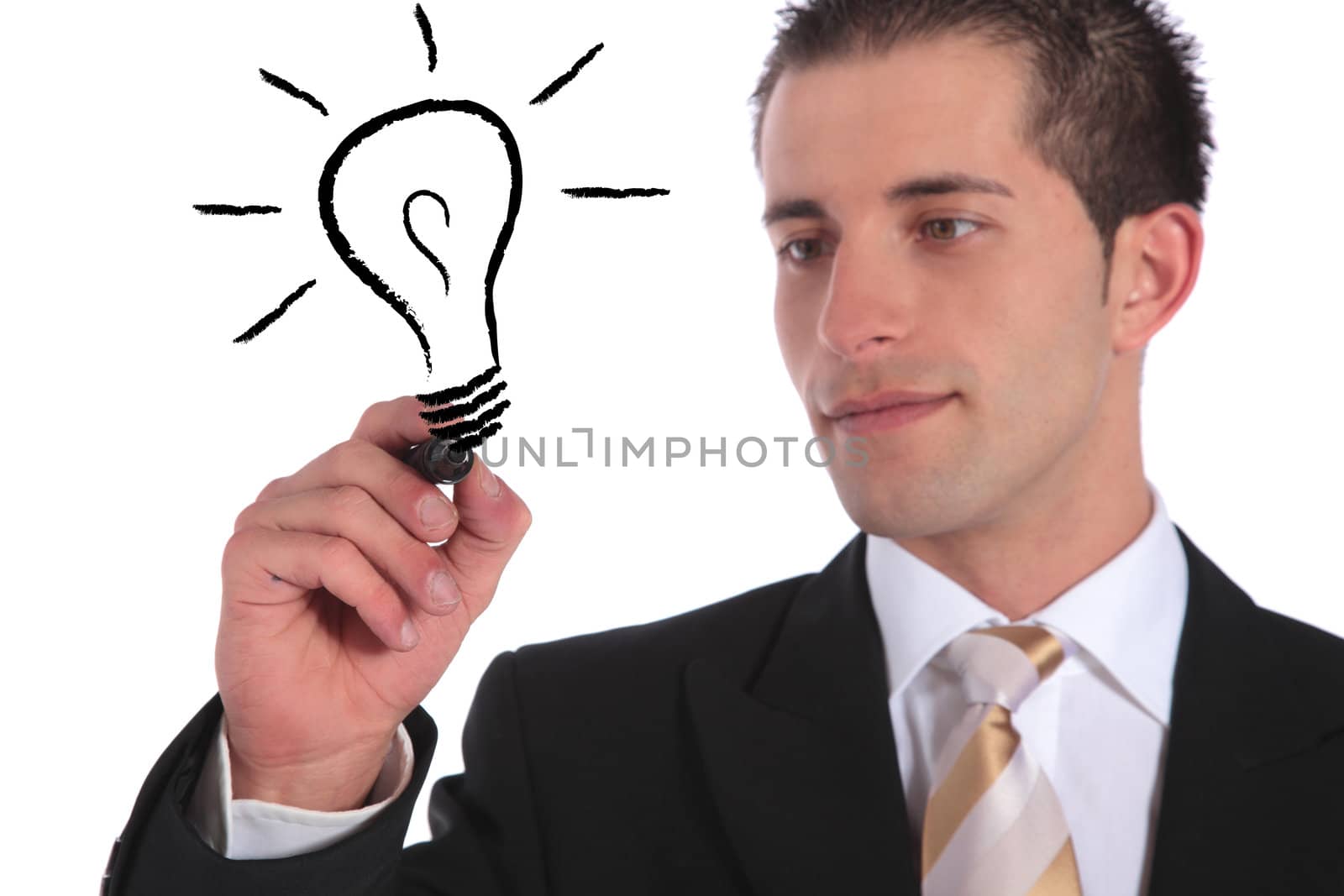 A handsome businessman sketching a lightbulb. All on white background.