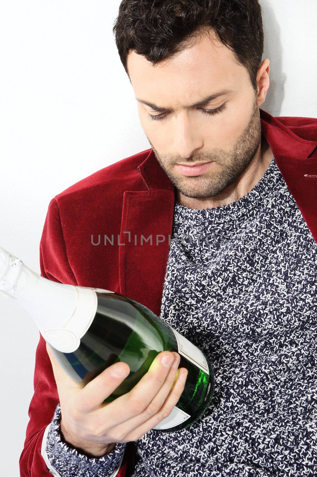 Portrait of male with a bottle of champagne by robert_przybysz