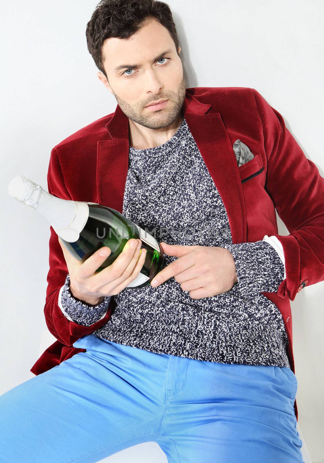 Portrait of male with a bottle of champagne by robert_przybysz