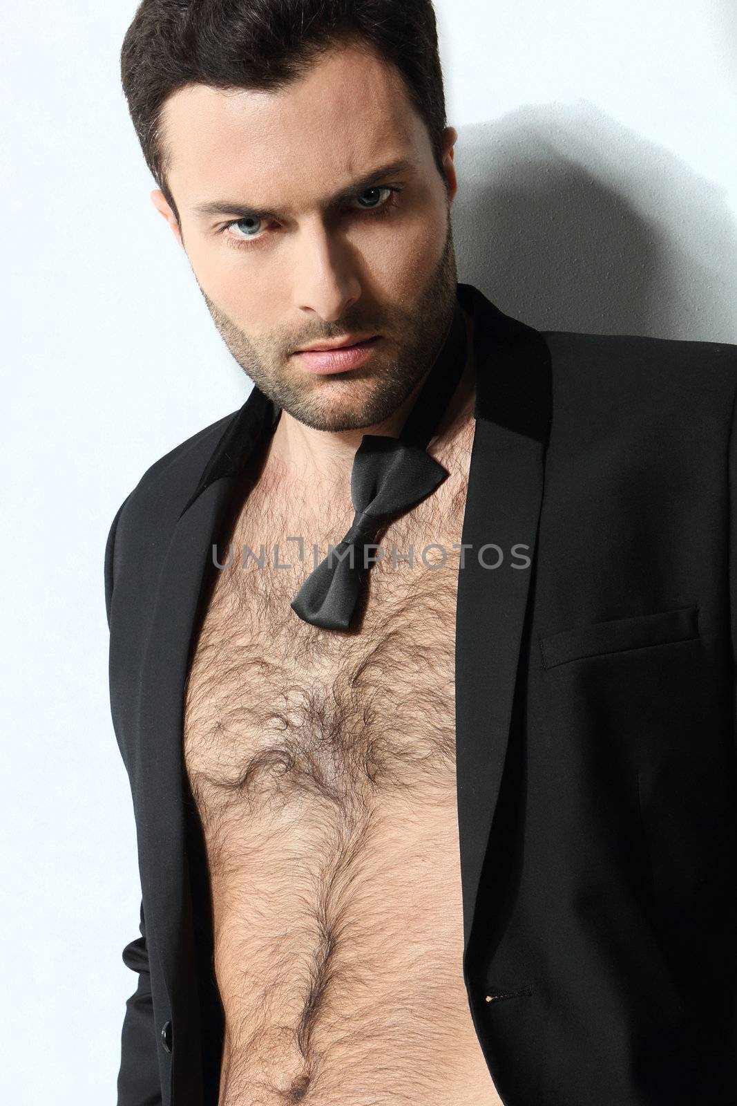 Great looking sexy male model with open shirt and loose bow tie by robert_przybysz