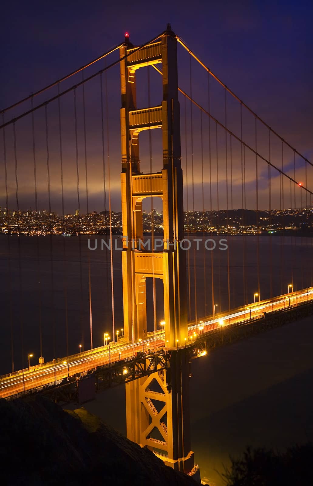 Golden Gate Bridge Night Vertical With Lights of San Francisco California in background