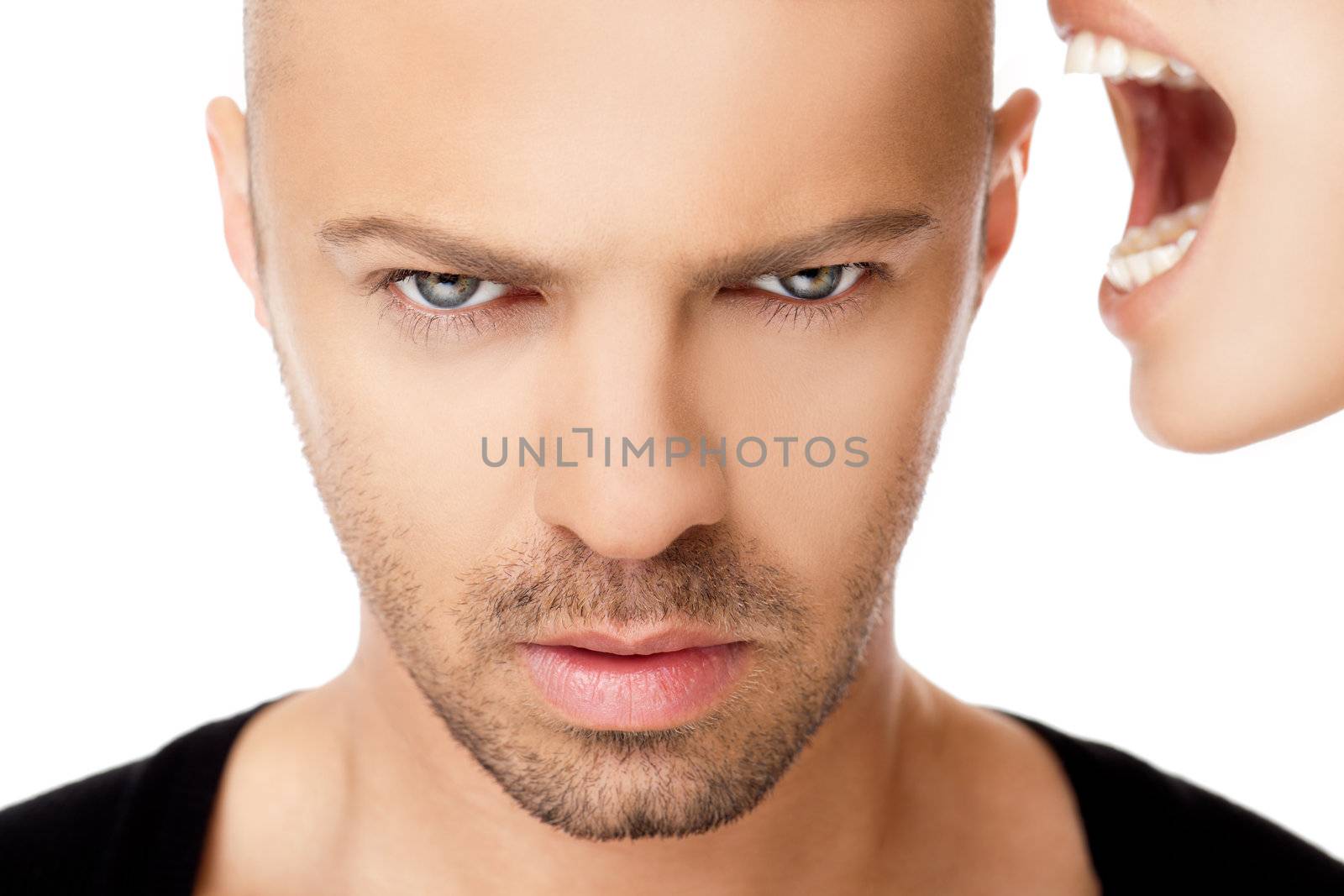 Close-up of hadsome young male face, cropped female screaming at his ear