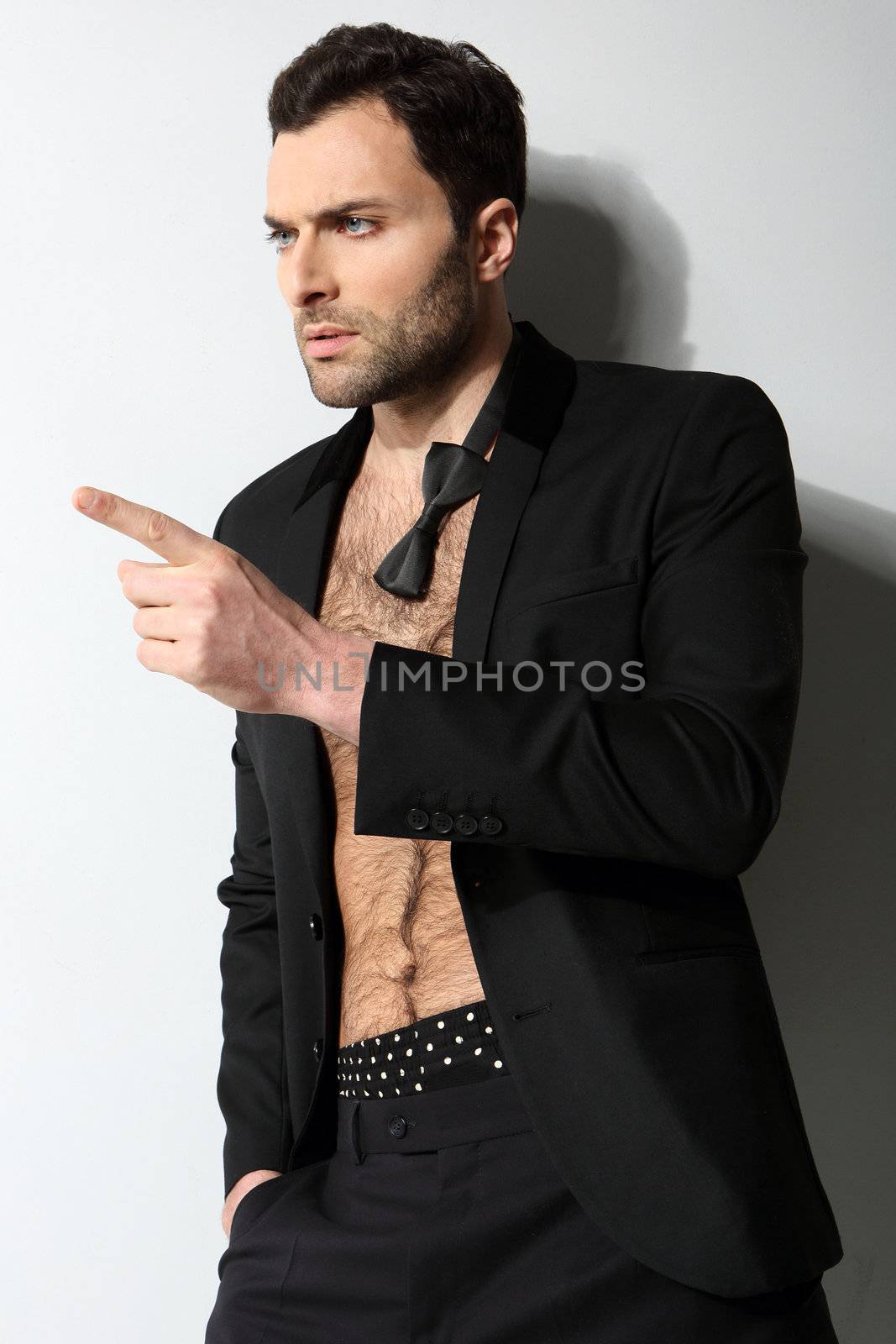 Great looking sexy male model with open shirt and loose bow tie by robert_przybysz
