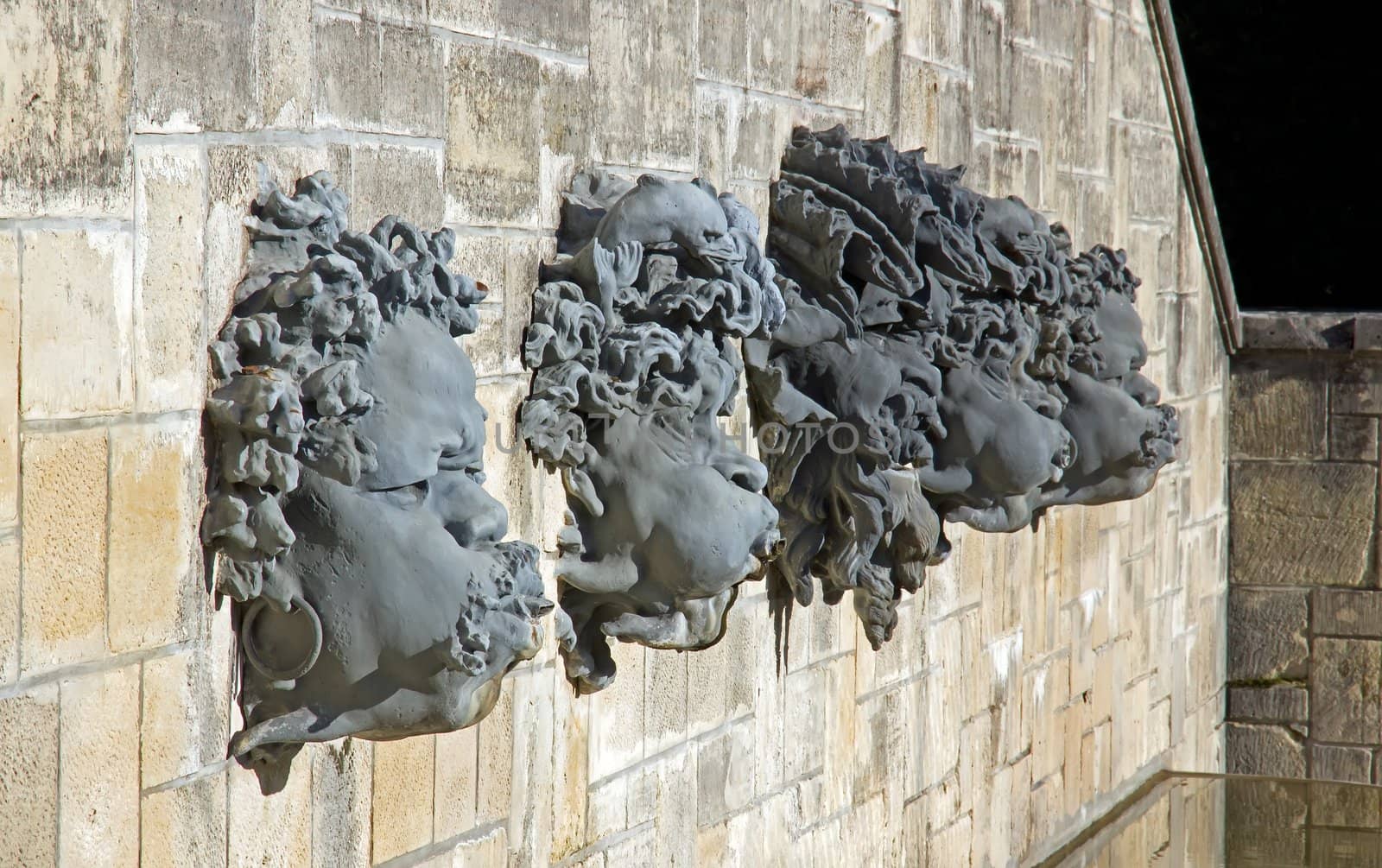 masks, head of a decorative fountain, a castle near Paris (France)