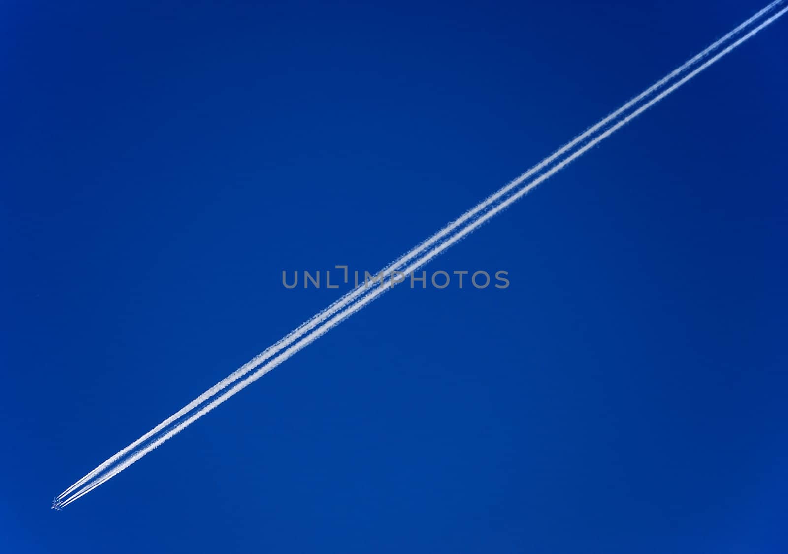Pure white line aircraft on blue sky