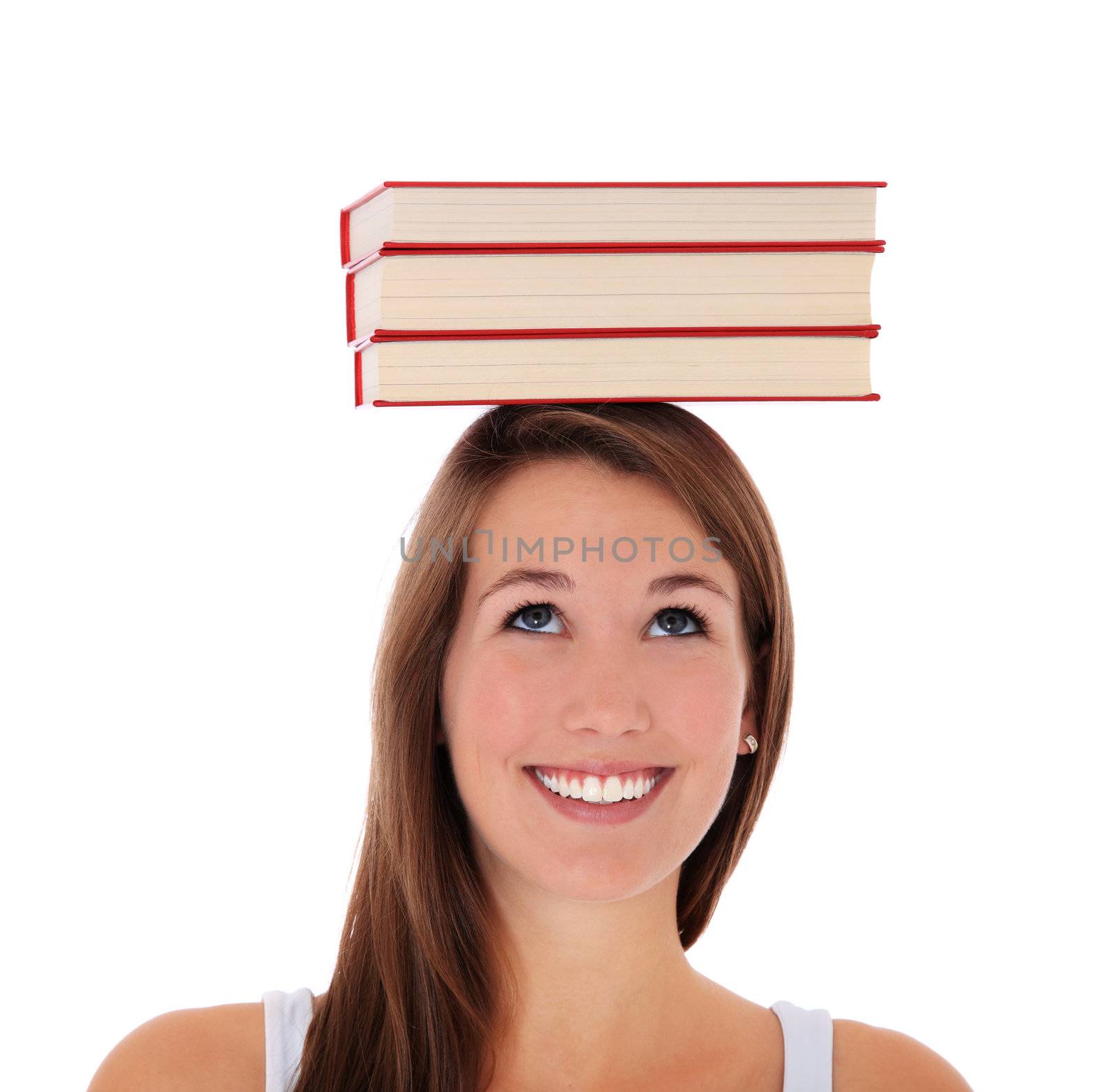 Attractive young woman balancing books on her head. All on white background.