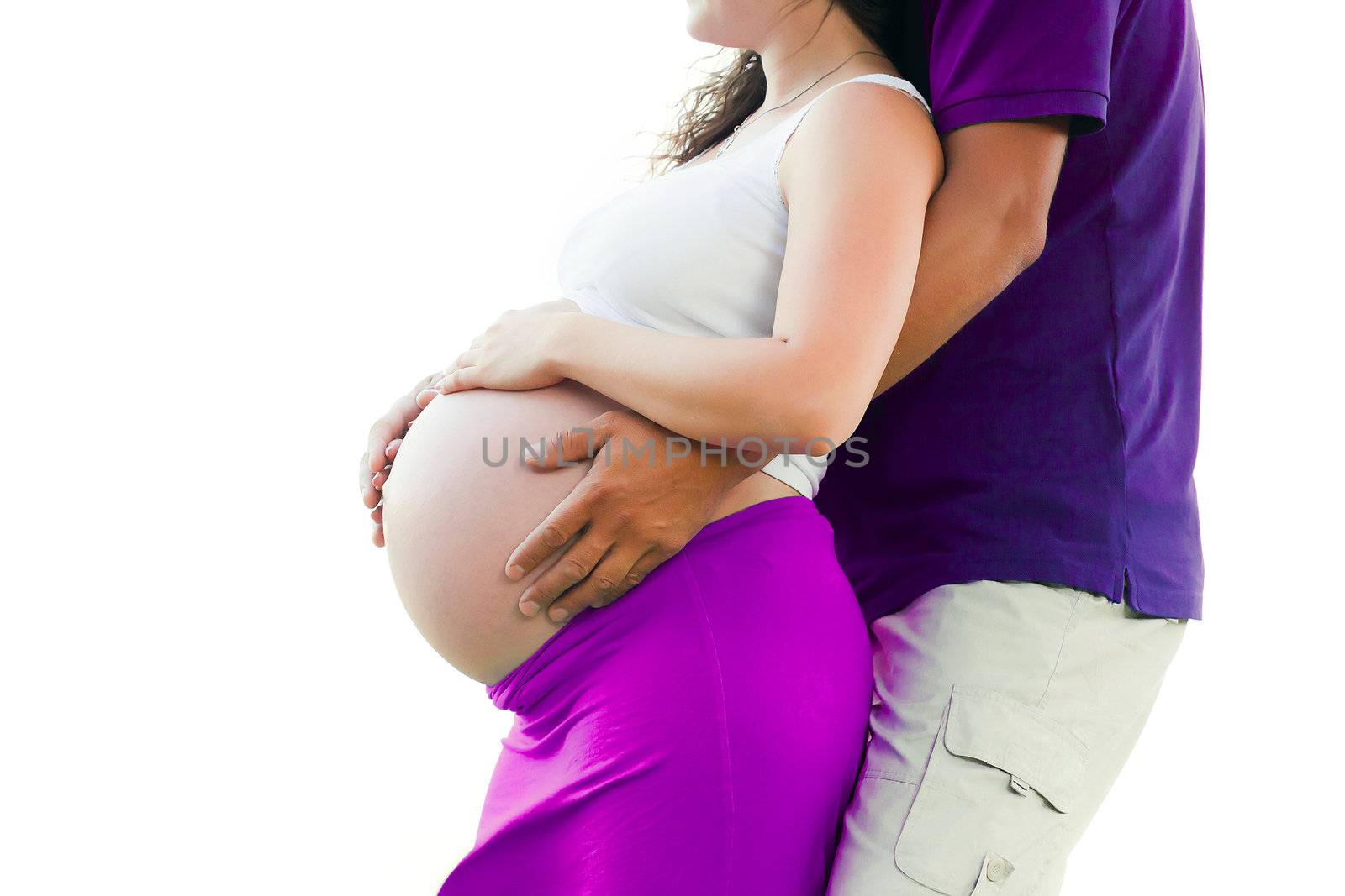 Pregnant woman holding hands around her belly 