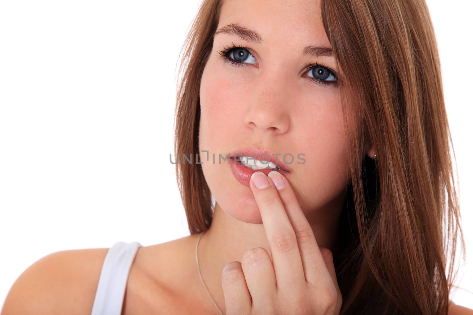 Attractive young woman checking her skin. All on white background.