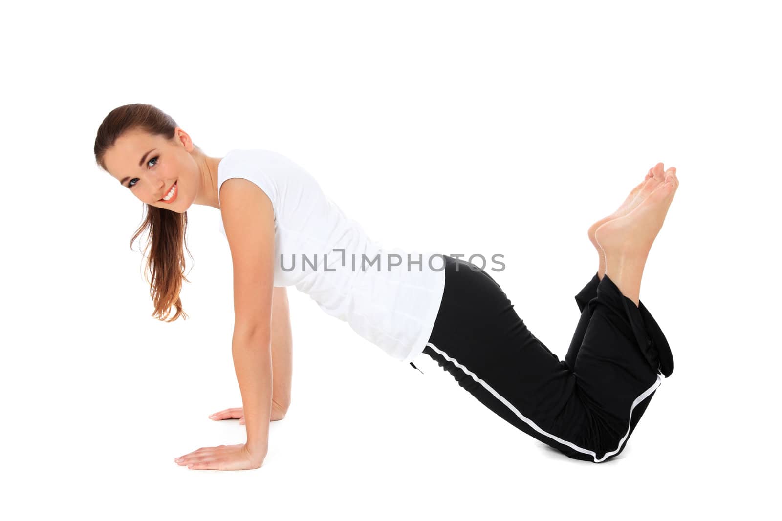 Attractive young woman in sports wear doing gymnastics. All on white background.