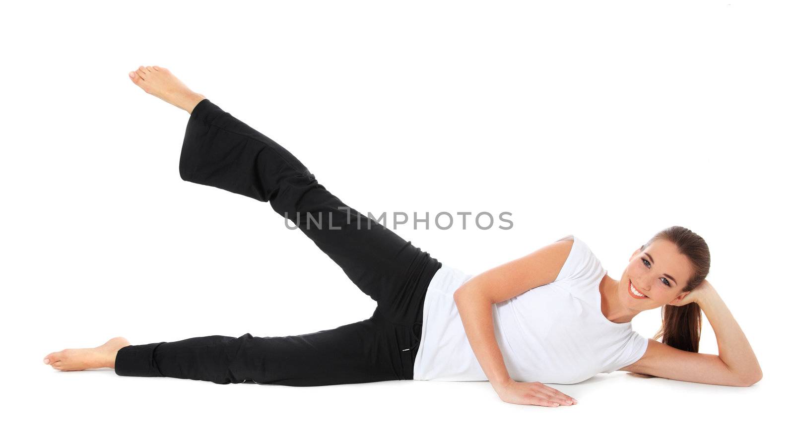 Attractive young woman in sports wear doing gymnastics. All on white background.