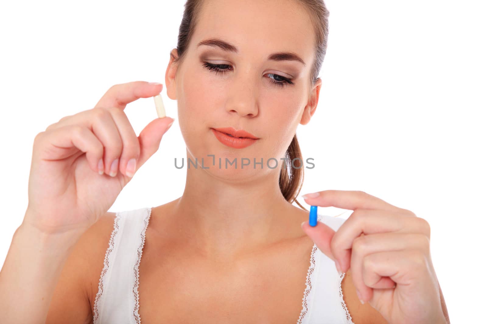 Attractive young woman taking pill. All on white background.