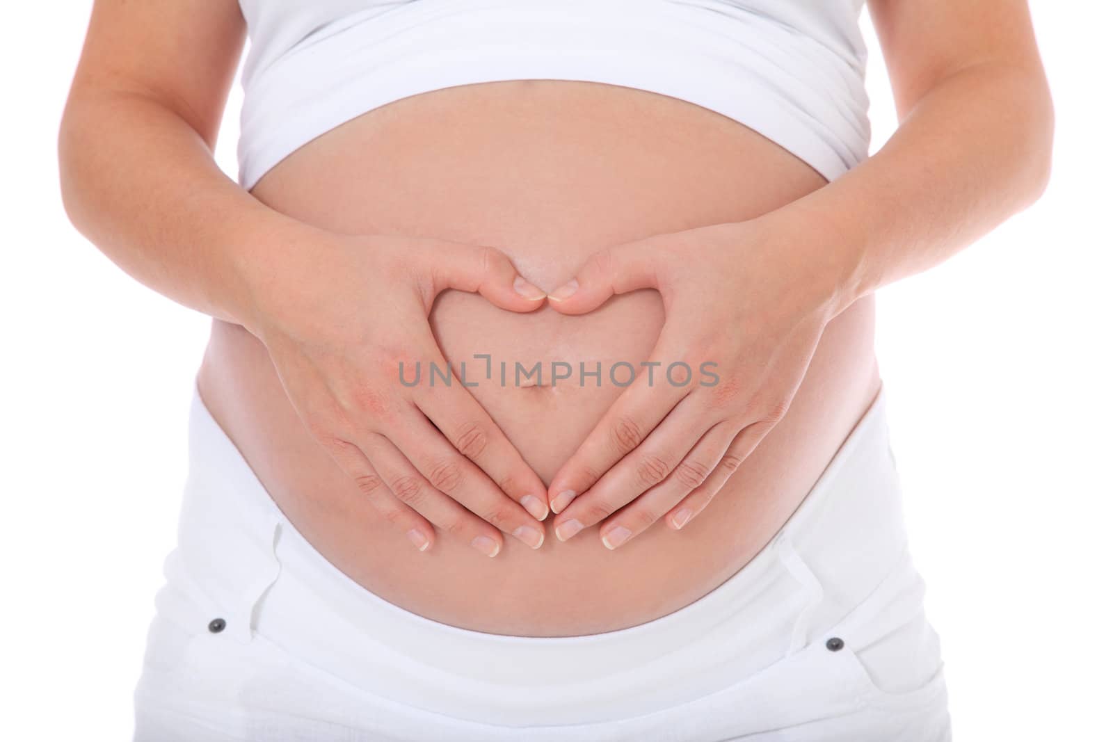 Pregnant woman forming heart out of her hands on her baby bump. All on white background.