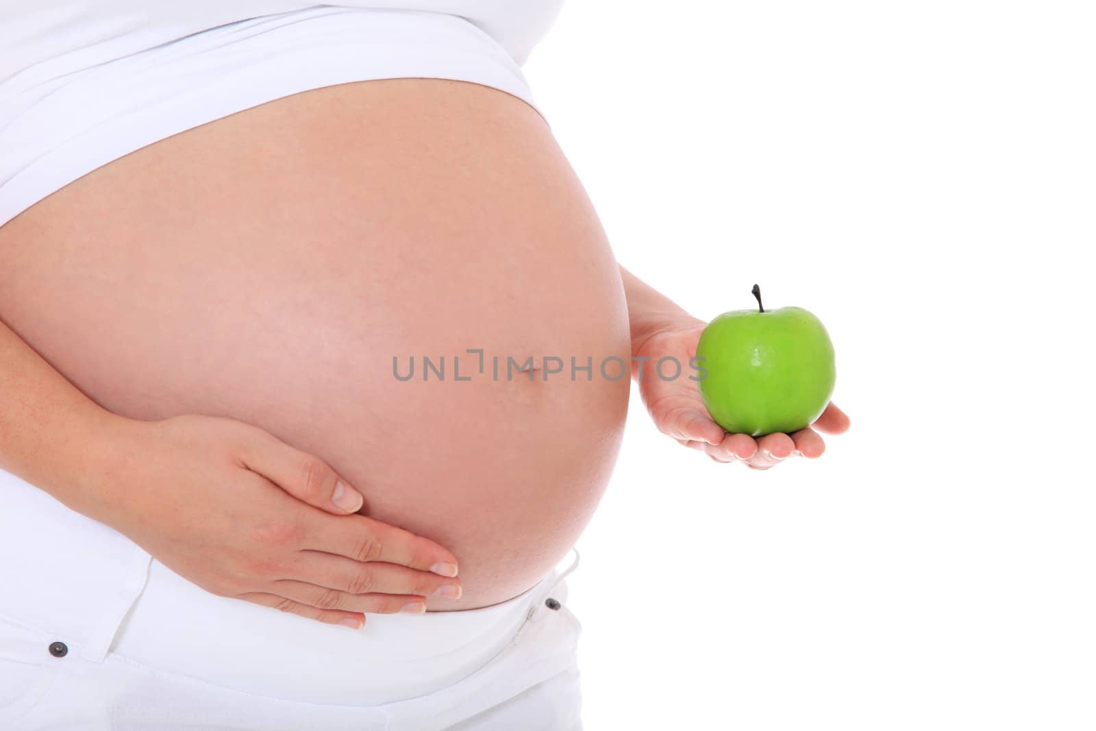 Pregnant woman holding fine green apple. All on white background.