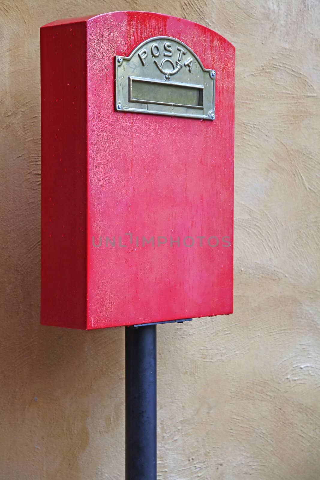 Red Italian Postal Box against Yellow Brick wall