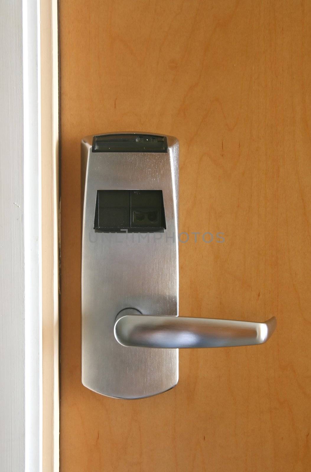 Keycard electronic lock on closed wooden door