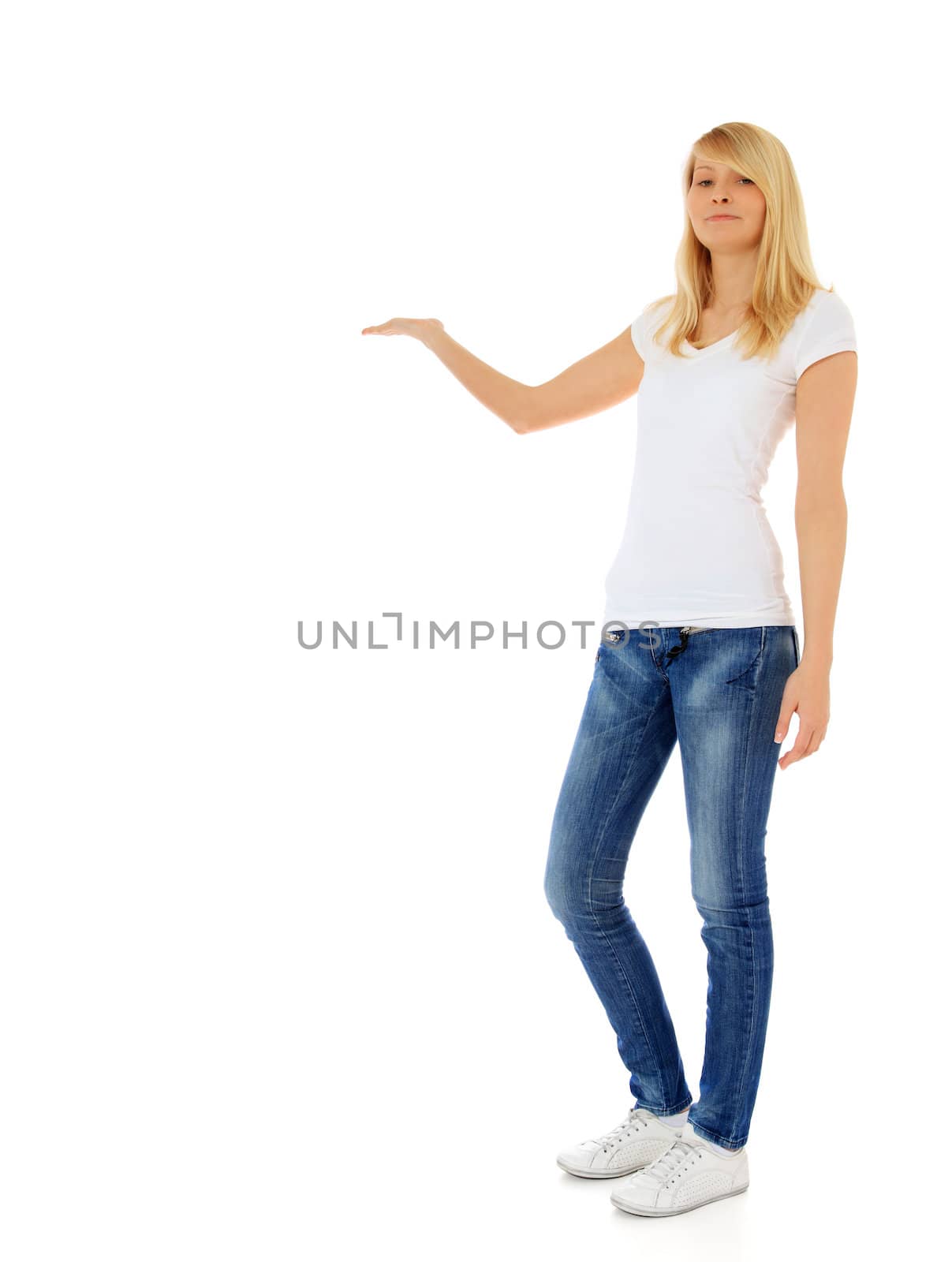 Attractive teenage girl pointing with finger. All on white background.