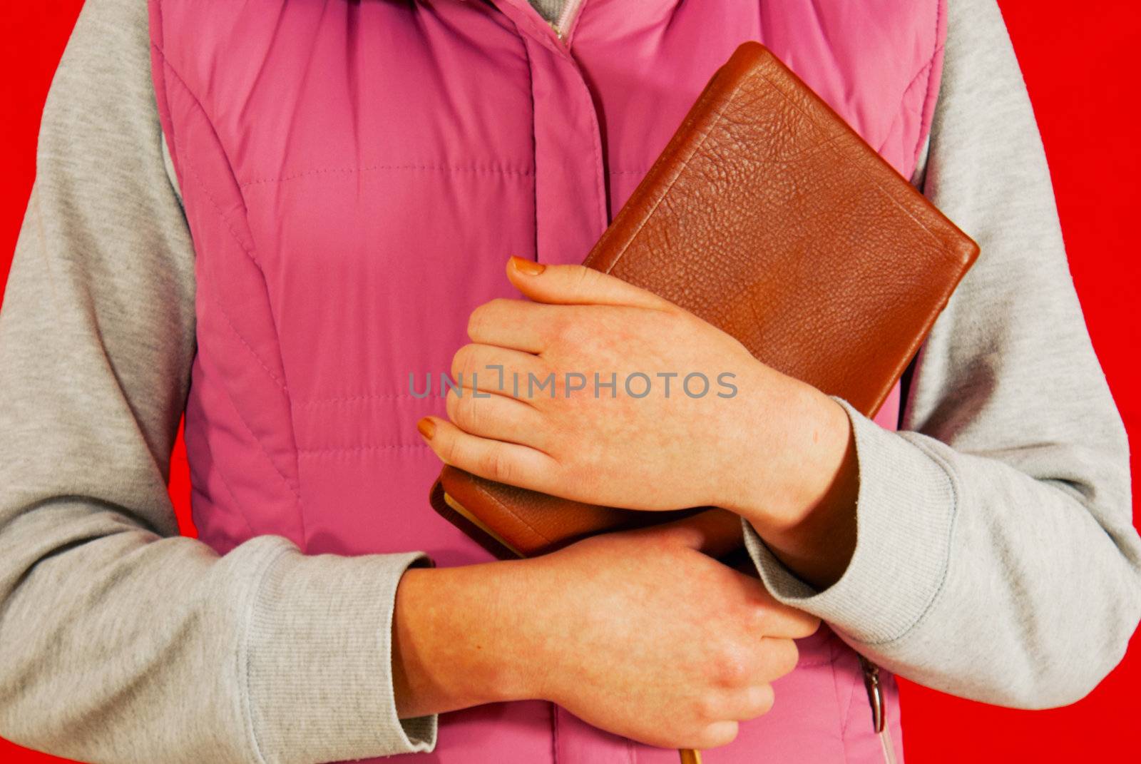 Unrecognizable female holding a book with her hands