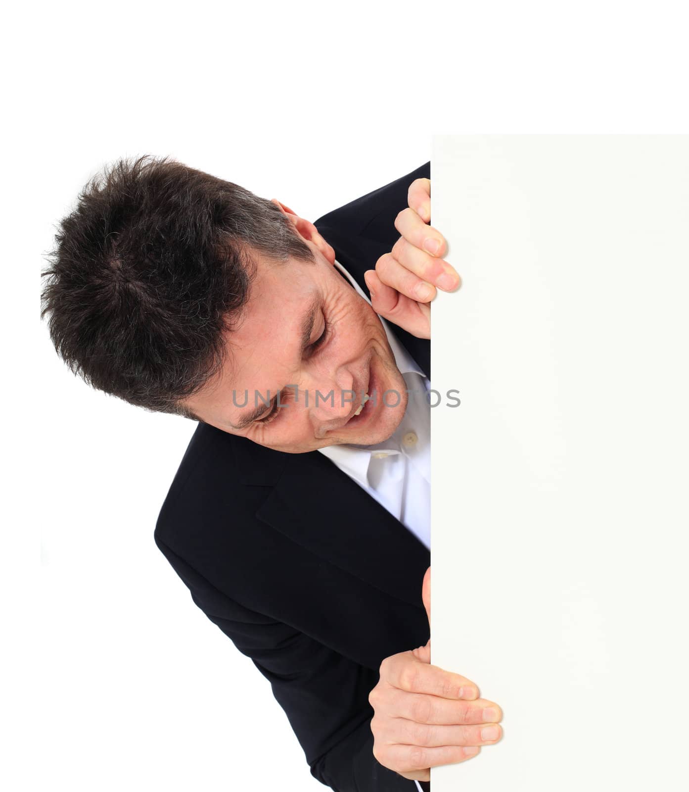 Attractive middle-aged man standing behind a white board. All on white background.